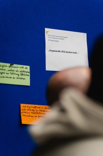 Close-up of Post-it notes on a blue bulletin board