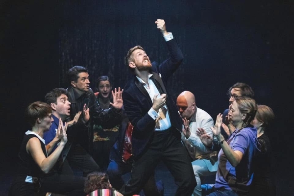 Performer Jim Libby on a stage with actors