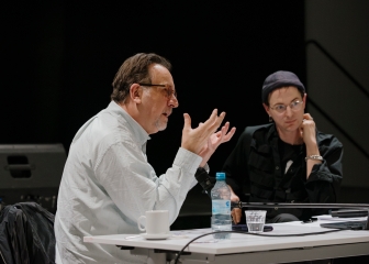 Richard Hawkins in conversation with Christian Liclair
                                          at a table in an event hall